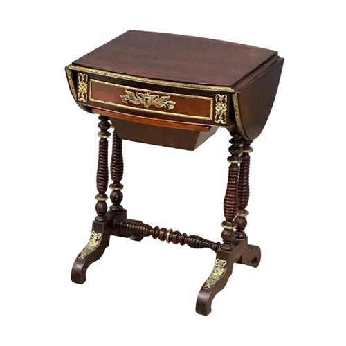 26 - A 19th Century mahogany drop leaf work table with brass ormolu mounts and bobbin turn supports. Circ... 