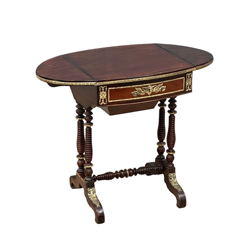 26 - A 19th Century mahogany drop leaf work table with brass ormolu mounts and bobbin turn supports. Circ... 