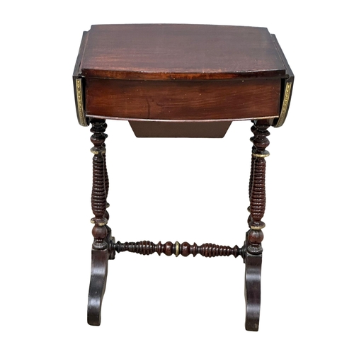 26 - A 19th Century mahogany drop leaf work table with brass ormolu mounts and bobbin turn supports. Circ... 