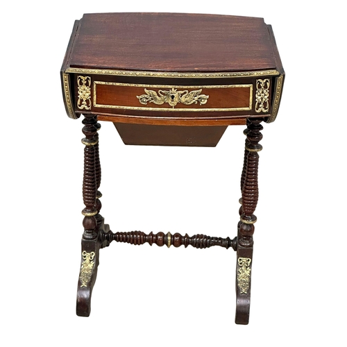 26 - A 19th Century mahogany drop leaf work table with brass ormolu mounts and bobbin turn supports. Circ... 