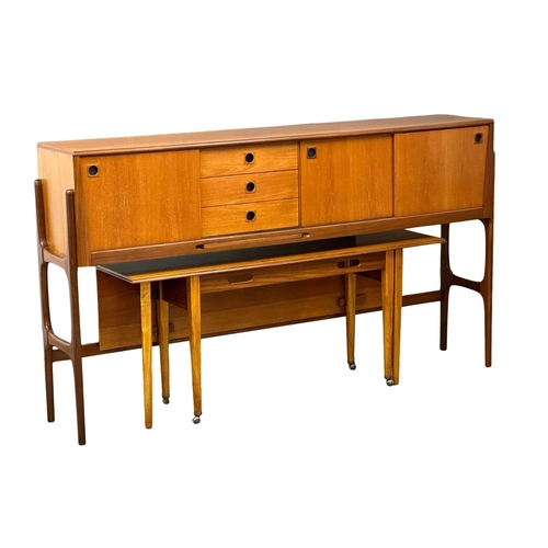 35 - Elliots of Newbury. A Mid Century teak credenza sideboard dinning room set. With 4 chairs and drop l... 