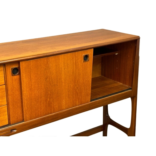 35 - Elliots of Newbury. A Mid Century teak credenza sideboard dinning room set. With 4 chairs and drop l... 