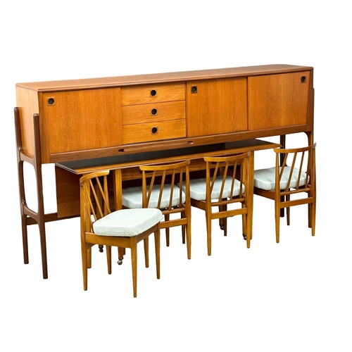 35 - Elliots of Newbury. A Mid Century teak credenza sideboard dinning room set. With 4 chairs and drop l... 