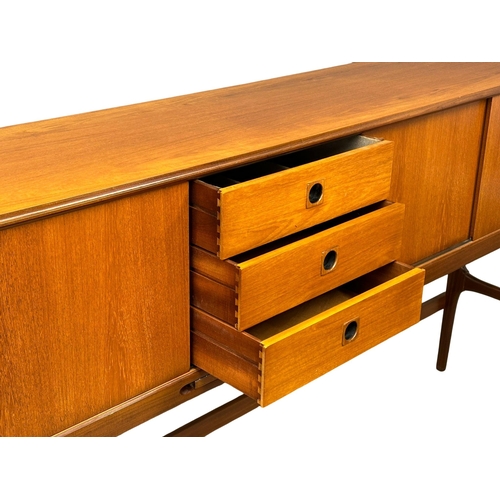 35 - Elliots of Newbury. A Mid Century teak credenza sideboard dinning room set. With 4 chairs and drop l... 