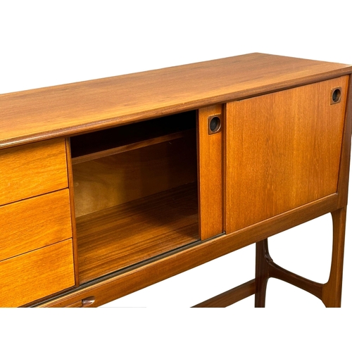 35 - Elliots of Newbury. A Mid Century teak credenza sideboard dinning room set. With 4 chairs and drop l... 