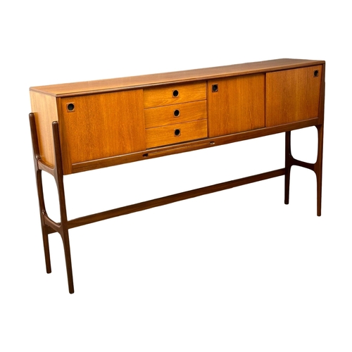 35 - Elliots of Newbury. A Mid Century teak credenza sideboard dinning room set. With 4 chairs and drop l... 