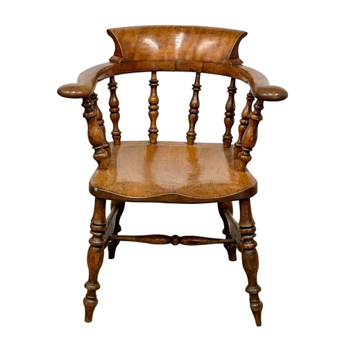 409 - A Victorian elm and beech elbow chair. (11)