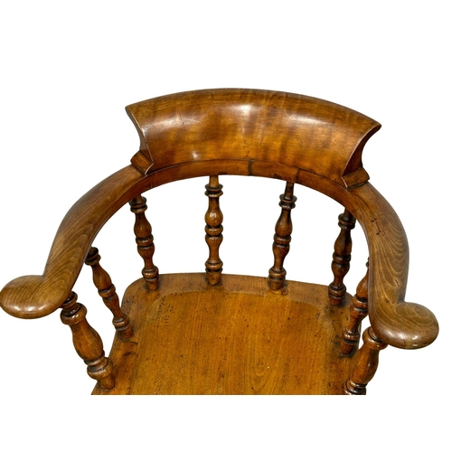 409 - A Victorian elm and beech elbow chair. (11)