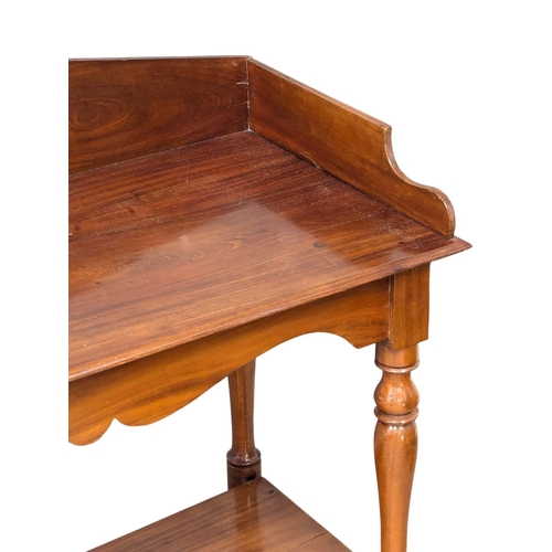 420 - A 19th Century Victorian mahogany side table with gallery back on turned legs. 103x48x95.5cm (8)