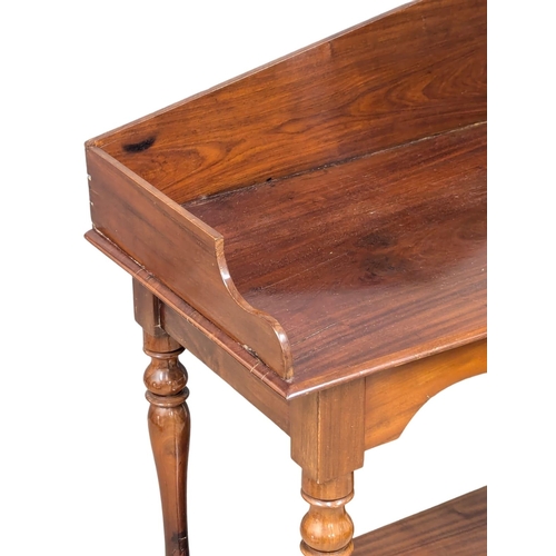 420 - A 19th Century Victorian mahogany side table with gallery back on turned legs. 103x48x95.5cm (8)