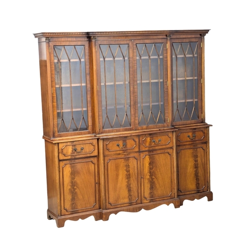 423 - A George III style mahogany breakfront bookcase with astragal glazed doors. 192x42x197cm (2)