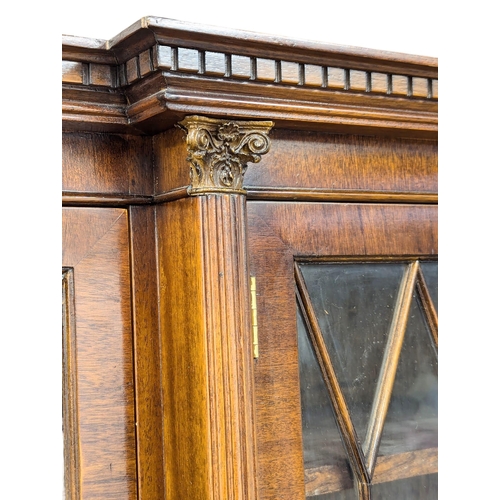 423 - A George III style mahogany breakfront bookcase with astragal glazed doors. 192x42x197cm (2)