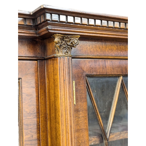 423 - A George III style mahogany breakfront bookcase with astragal glazed doors. 192x42x197cm (2)