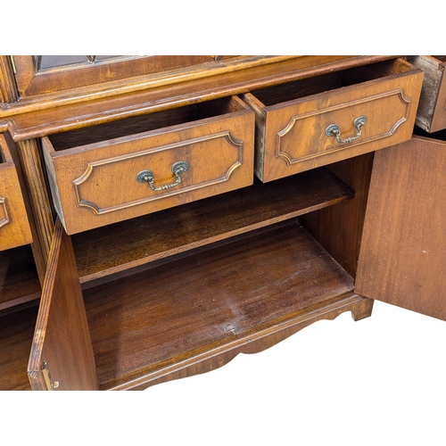 423 - A George III style mahogany breakfront bookcase with astragal glazed doors. 192x42x197cm (2)