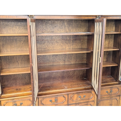 423 - A George III style mahogany breakfront bookcase with astragal glazed doors. 192x42x197cm (2)