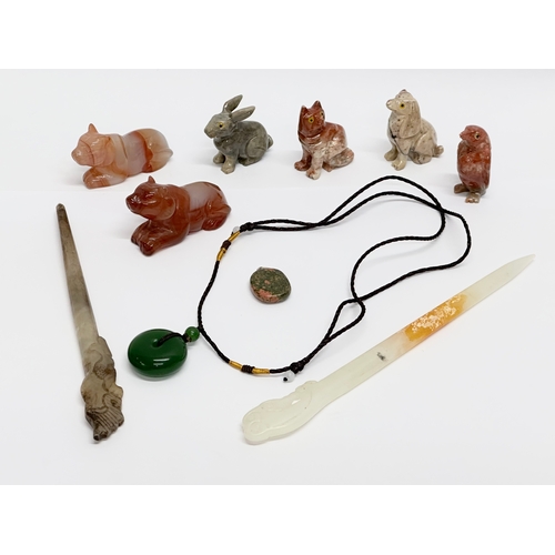 295 - A collection of Chinese polished stone miniatures and a jade necklace.