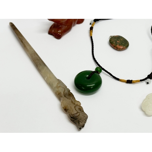 295 - A collection of Chinese polished stone miniatures and a jade necklace.