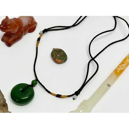 295 - A collection of Chinese polished stone miniatures and a jade necklace.