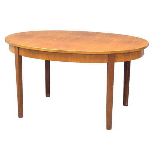 534 - A G-Plan Mid Century teak extending dining table. 185x101x73cm  (4)