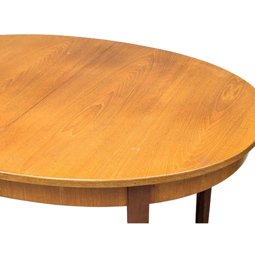 534 - A G-Plan Mid Century teak extending dining table. 185x101x73cm  (4)