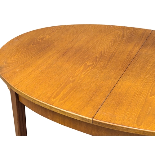 534 - A G-Plan Mid Century teak extending dining table. 185x101x73cm  (4)