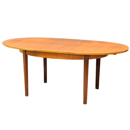 534 - A G-Plan Mid Century teak extending dining table. 185x101x73cm  (4)