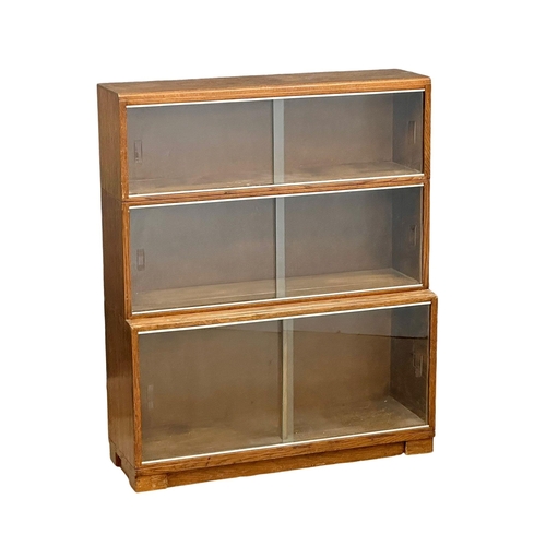 542 - A vintage Minty oak stacking bookcase. 89x29x107.5cm. 1