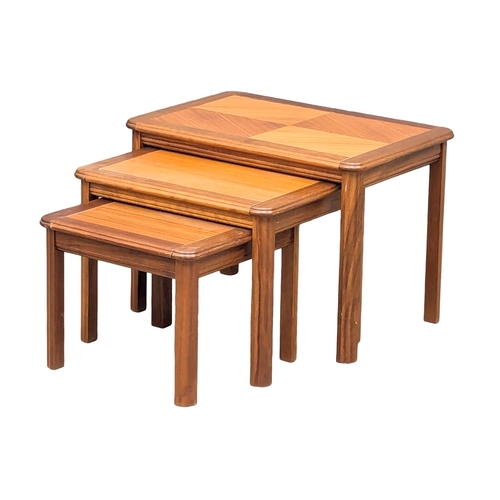 554 - A Danish Mid Century teak nest of tables. 6