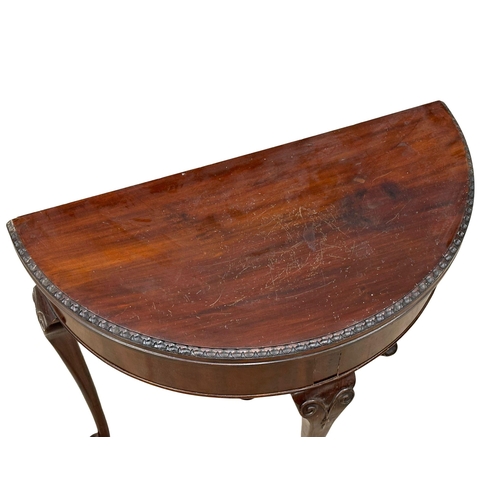 576 - A 1930’s Georgian style mahogany games table. 78x39x75cm (2)