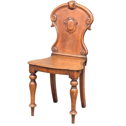 579 - A Victorian mahogany hall chair (2)