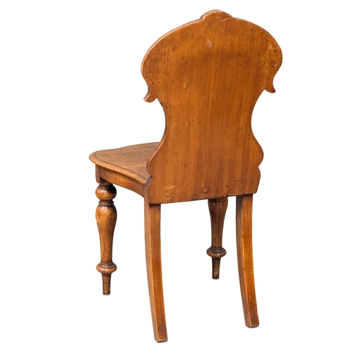 579 - A Victorian mahogany hall chair (2)