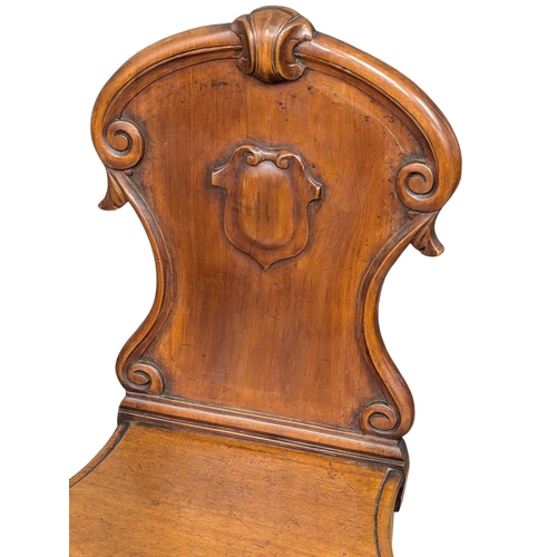 579 - A Victorian mahogany hall chair (2)