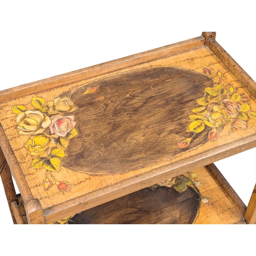 580 - A 1930s walnut two tiered serving trolley with poker work decoration. 64x38x76cm (2)