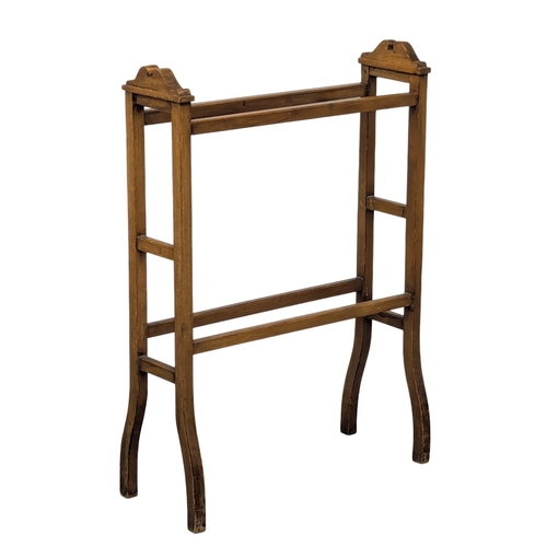 582 - A Late 19th Century pine towel rail. (3)