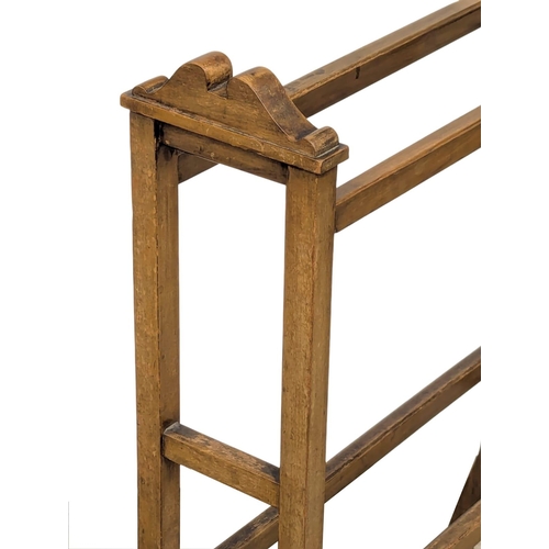 582 - A Late 19th Century pine towel rail. (3)