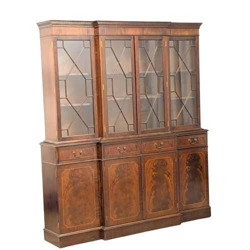 671 - A large Georgian style inlaid mahogany breakfront bookcase with astragal glazed doors. 182x40x208cm.... 