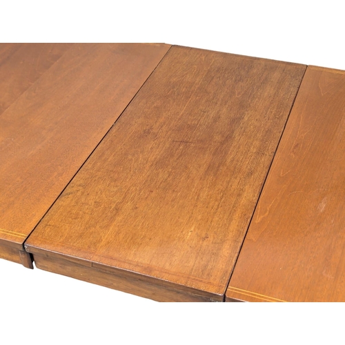 695 - A Sheraton style inlaid mahogany extending dining table. 224.5x93x73cm (2)