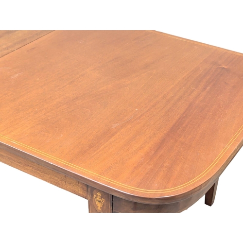 695 - A Sheraton style inlaid mahogany extending dining table. 224.5x93x73cm (2)