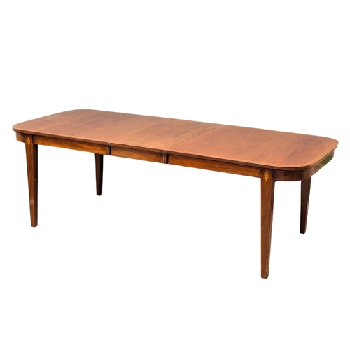 695 - A Sheraton style inlaid mahogany extending dining table. 224.5x93x73cm (2)