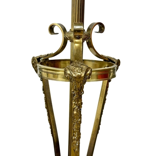 70 - A large good quality Early 20th Century brass standard lamp., with rams head decoration on hairy hoo... 