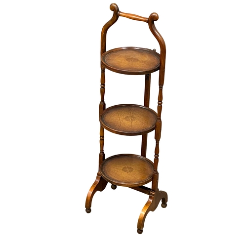 827 - A mahogany 3 tier cake stand with leather panels. (2)