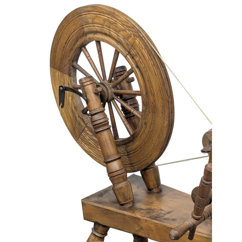 834 - A Victorian style spinning wheel. 96cm