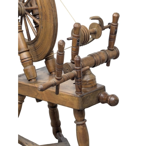 834 - A Victorian style spinning wheel. 96cm