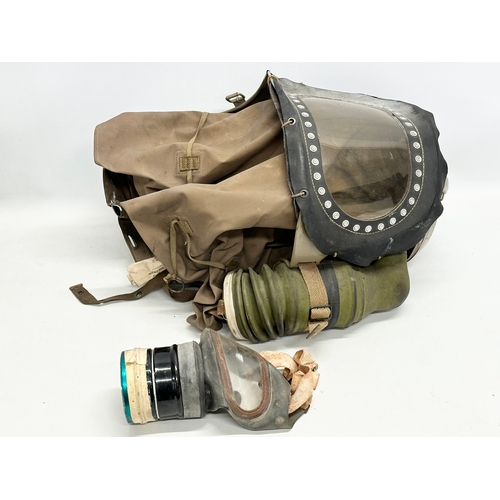 740 - A WWII baby’s gas mask and other. Dated 1939.