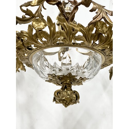 63 - A good quality Early 20th Century French brass and crystal, rococo style chandelier, with 6 branches... 