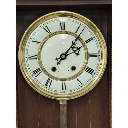 454 - A large Victorian style Vienna wall clock with double weights and pendulum. 120cm