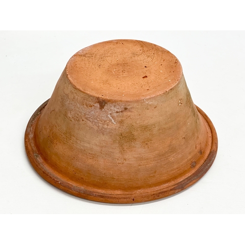 66 - Coalisland Slipware. A Late 19th Century Northern Irish glazed terracotta dairy bowl. 26.5x12cm.