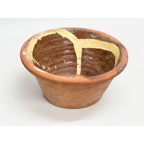 66 - Coalisland Slipware. A Late 19th Century Northern Irish glazed terracotta dairy bowl. 26.5x12cm.