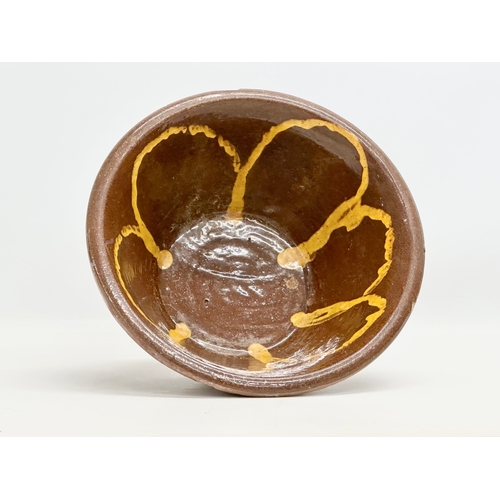 67 - Coalisland Slipware. A Late 19th Century Northern Irish glazed terracotta dairy bowl. 32x13cm.