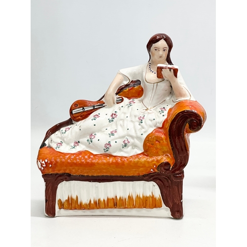 133 - A pair of 19th Century Victorian Staffordshire Pottery chaise lounge bookends/figurines. Circa 1850-... 